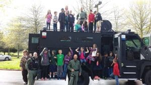 Students ride to school in a SWAT vehicle